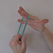Nina using an elastic band for finger extensor exercises
